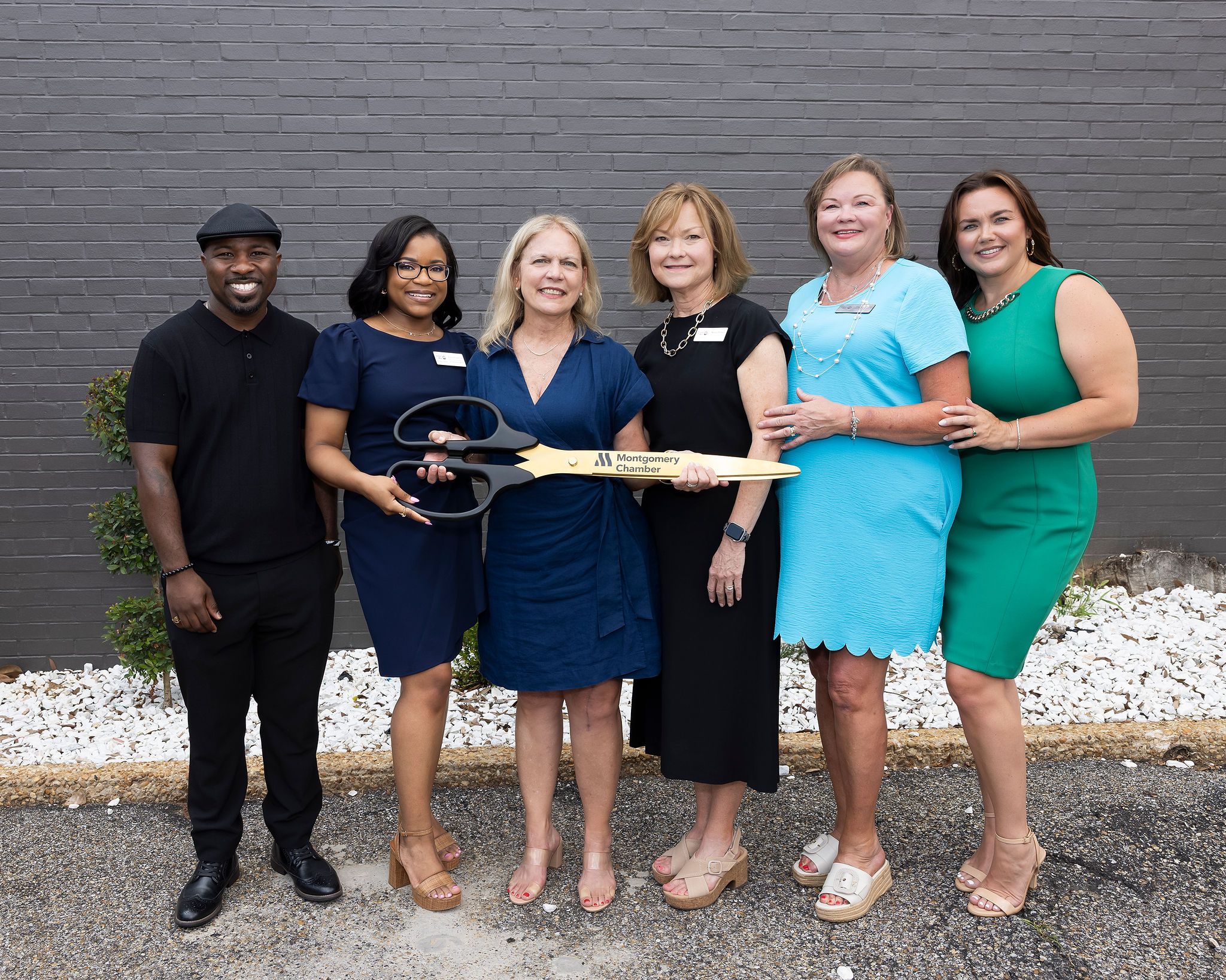 RRUW staff with ribbon cutting scissors
