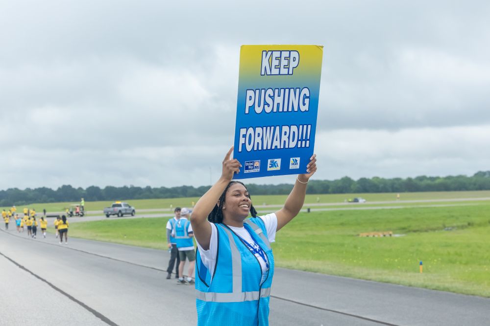 volunteer holds sign
