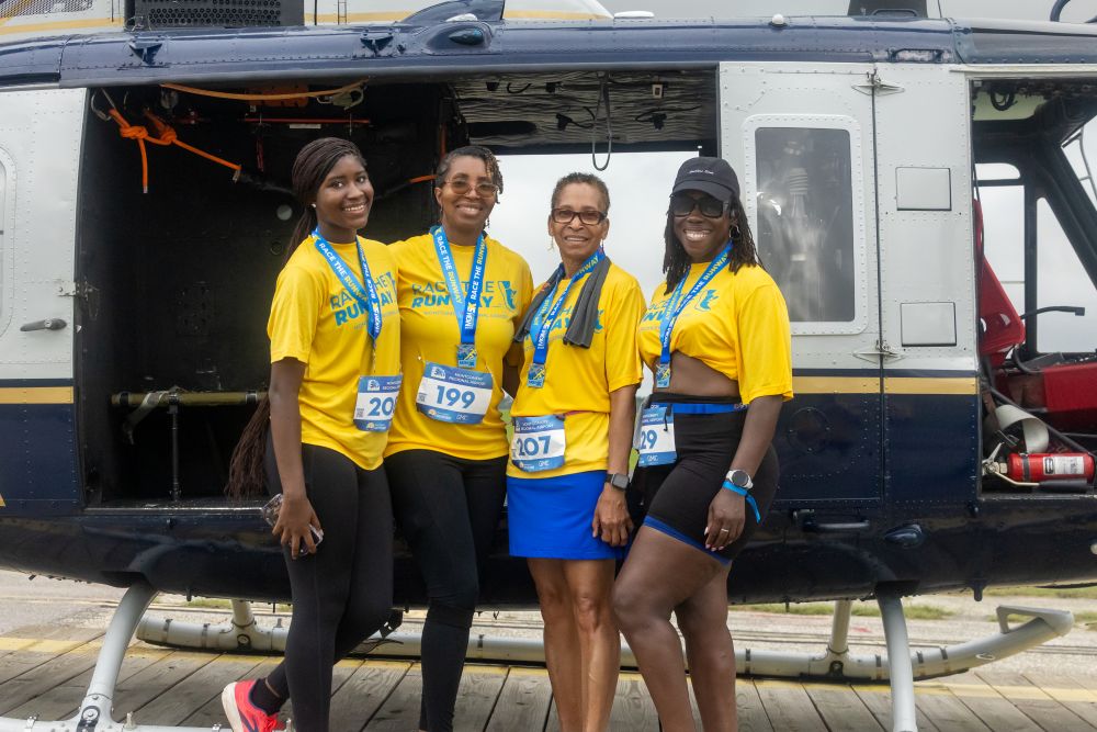 runners in front of helicopter