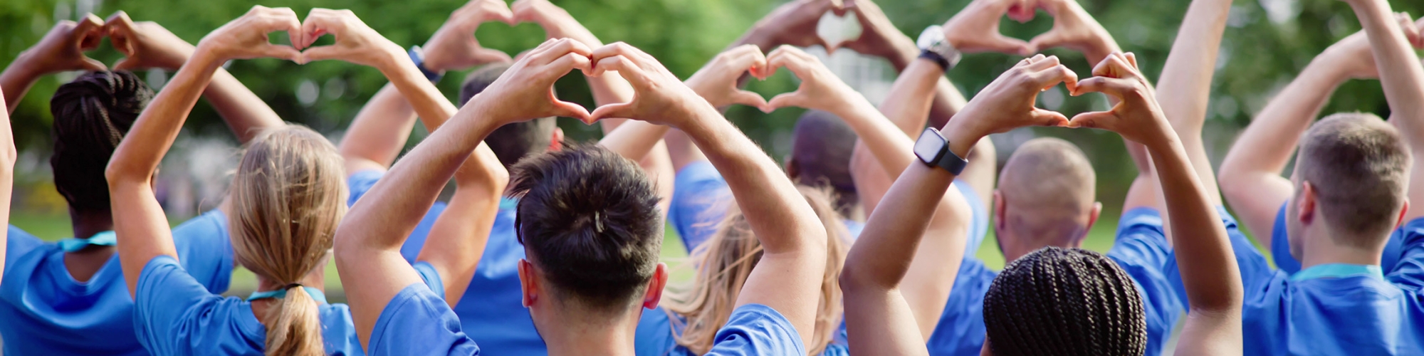 group of people holding heart hands
