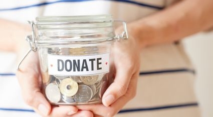 hands holding jar full of coins